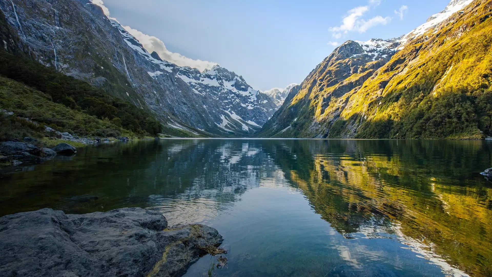 Peaks of Darran Mountains reflecting in a Lake Marian, Fiordland national park, New Zealand South island